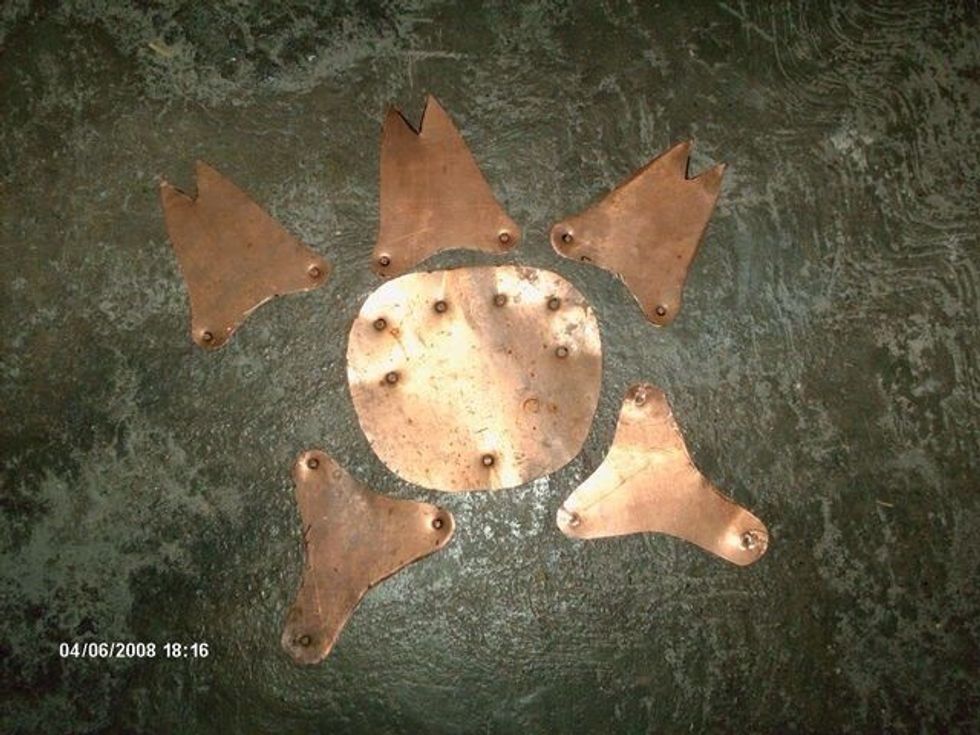 Draw the shape of the finger stalls and backplate on the copper sheet by using the patterns and a sharpie. In the movies, brass was used to make the backplate, but for this guide I used copper.