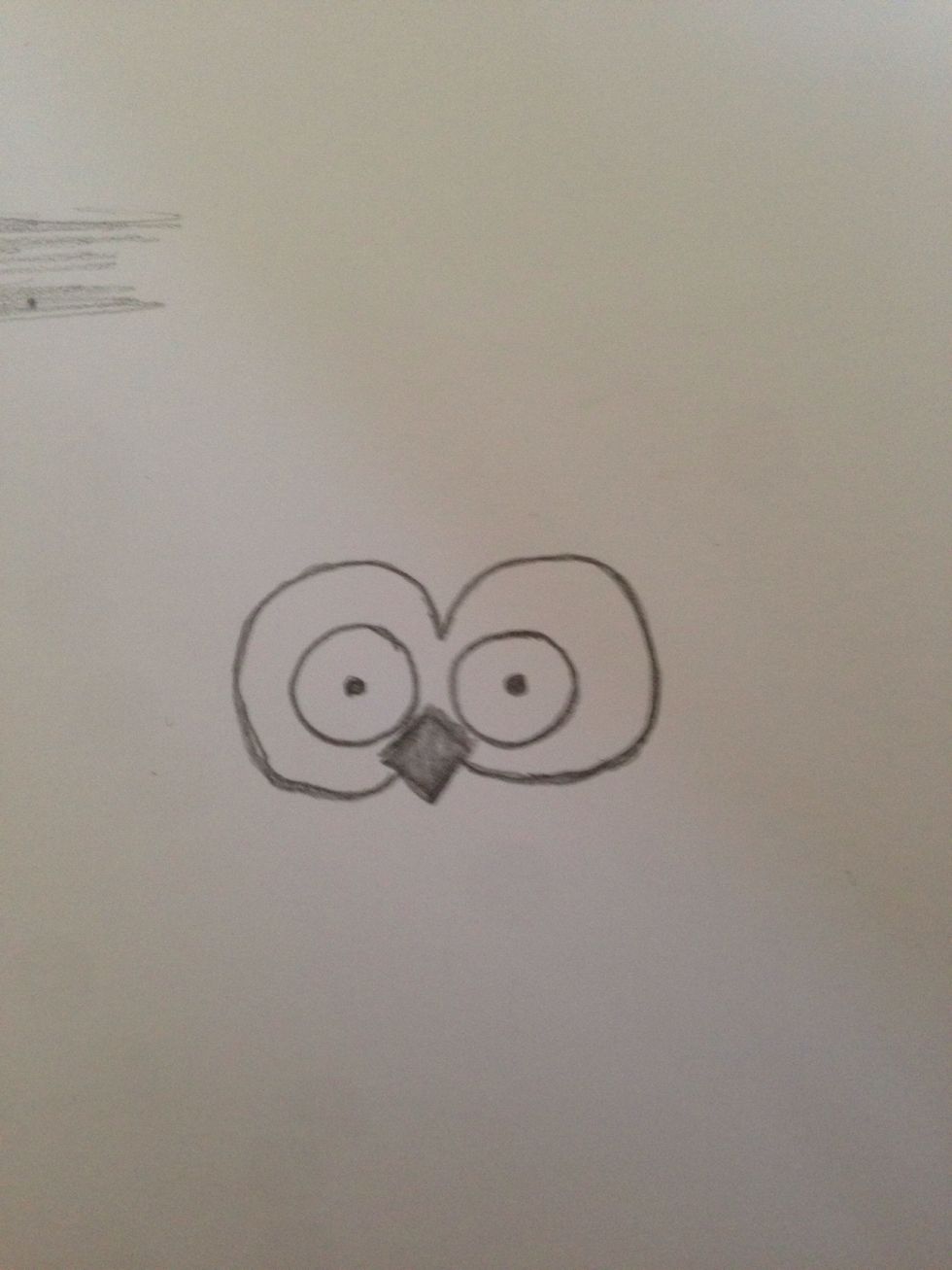 Draw two bigger circles around what you've already done and join them together