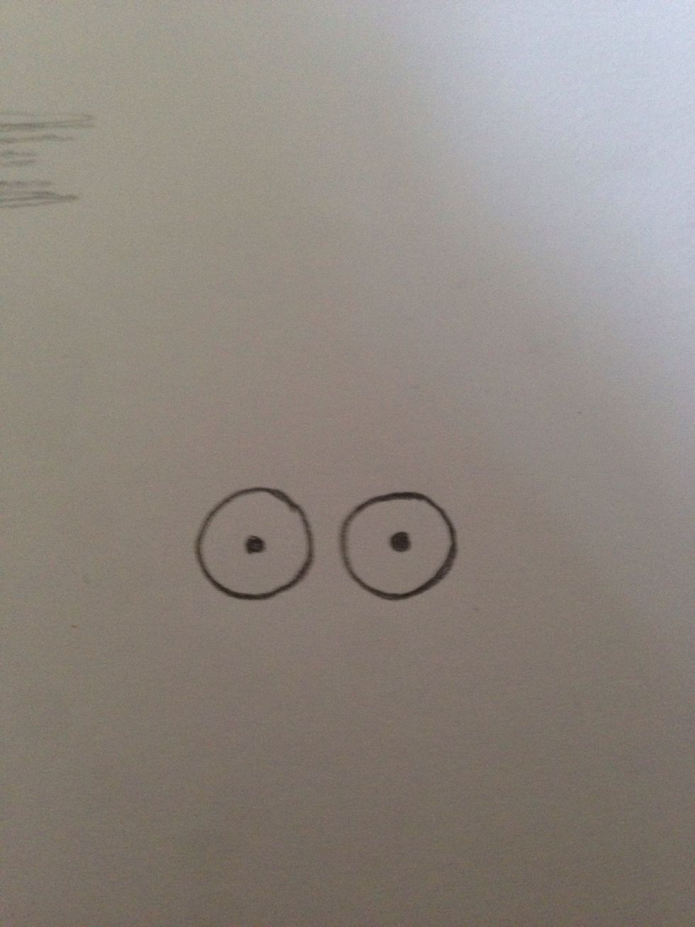 Draw two circles with dots in the middle