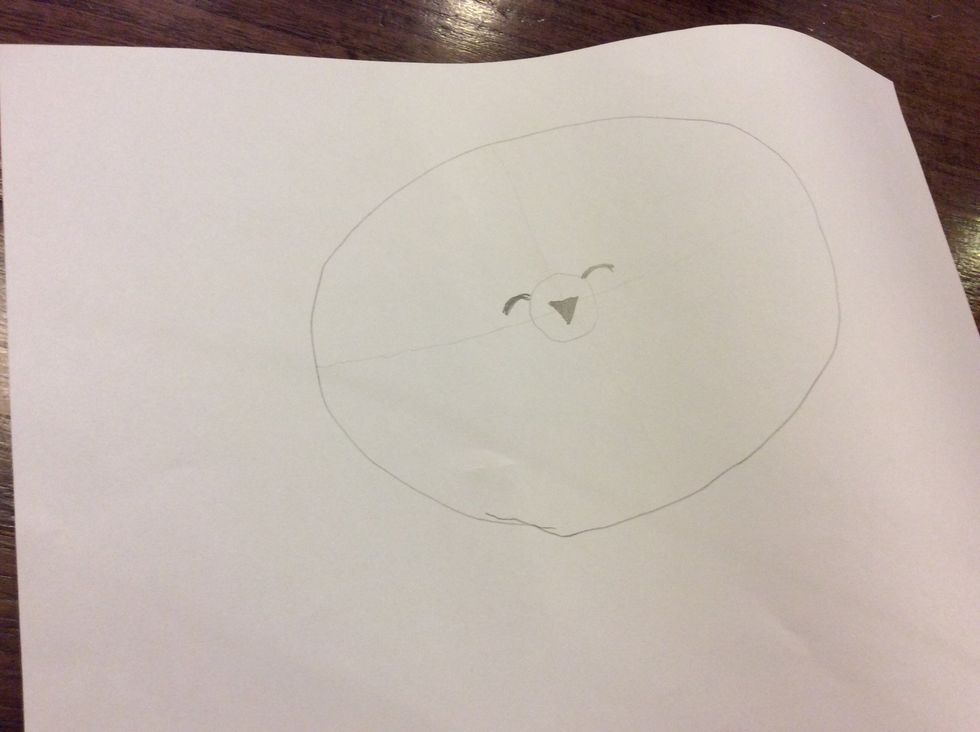 Draw two half circles on both sides of the smaller circle.