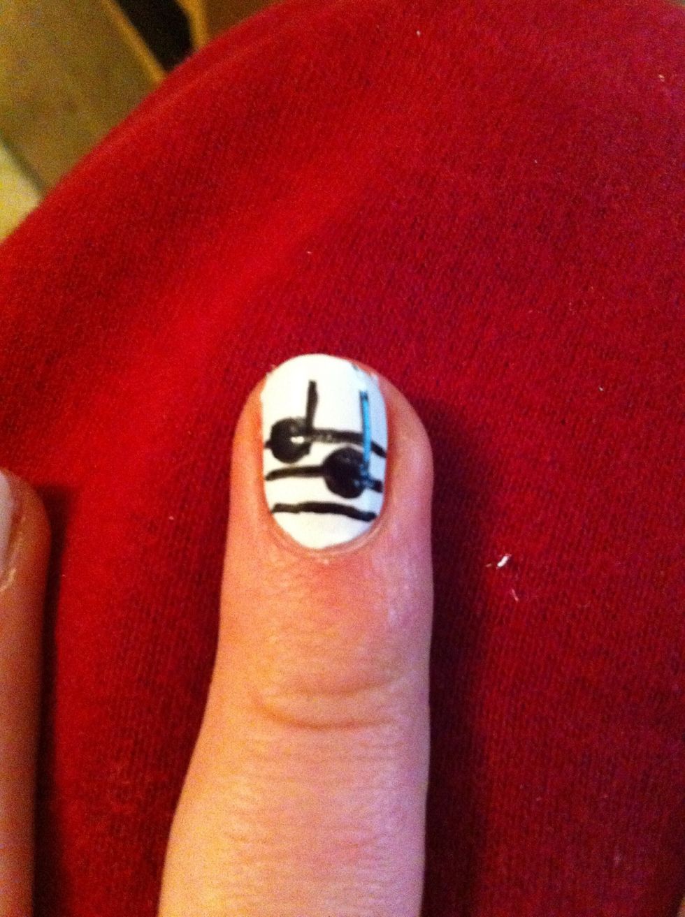 Draw two lines coming off the side of your dots towards the top of your nail- try to finish them on the same level (with eyeliner you can wash it off if it goes wrong)