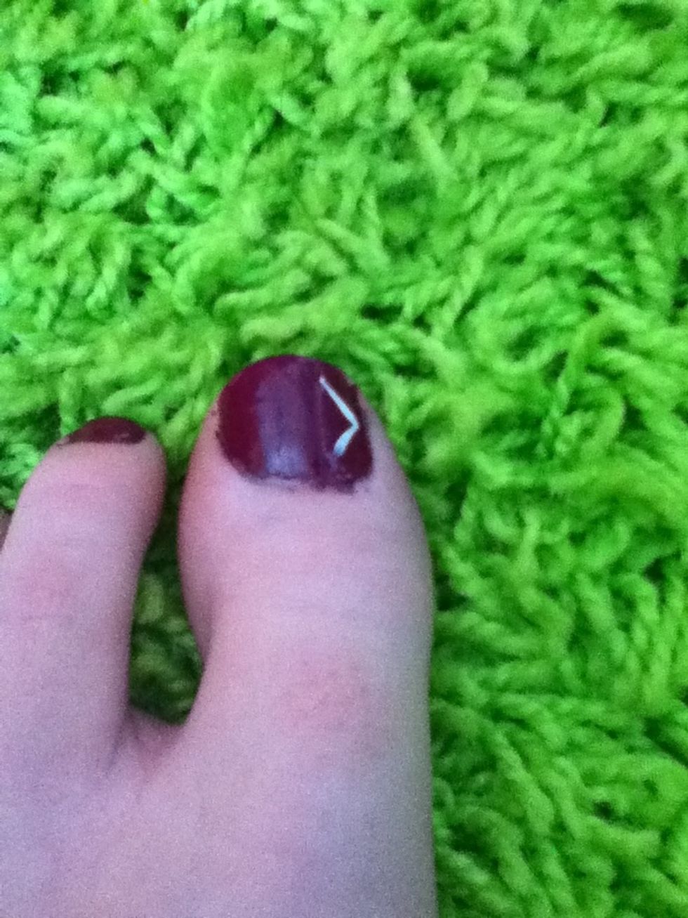 Draw two lines like this. Remember, it doesn't have to be perfect, and we can always go over it again if the white doesn't show up on your nail color.