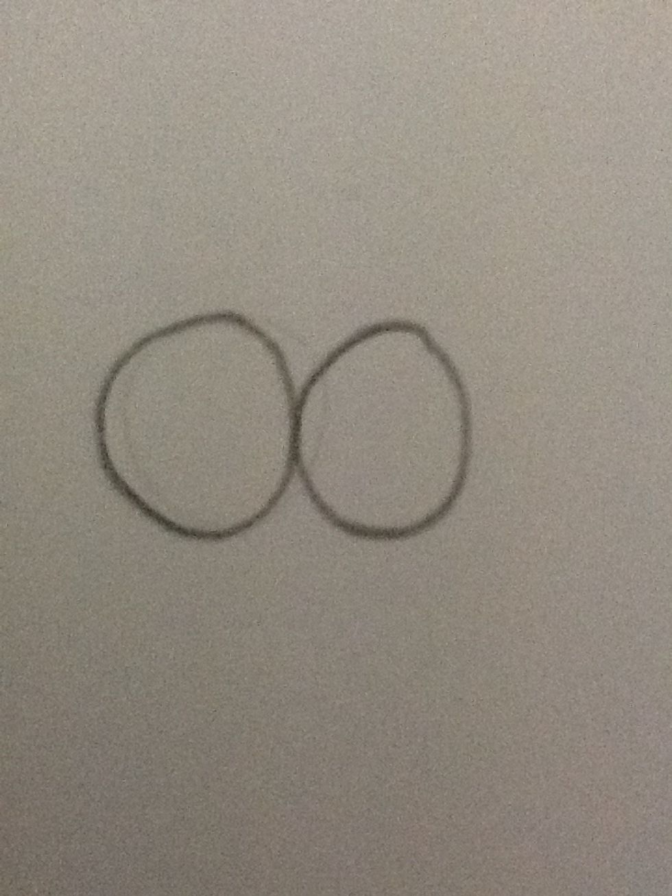 Draw two round circles in the middle of your page.