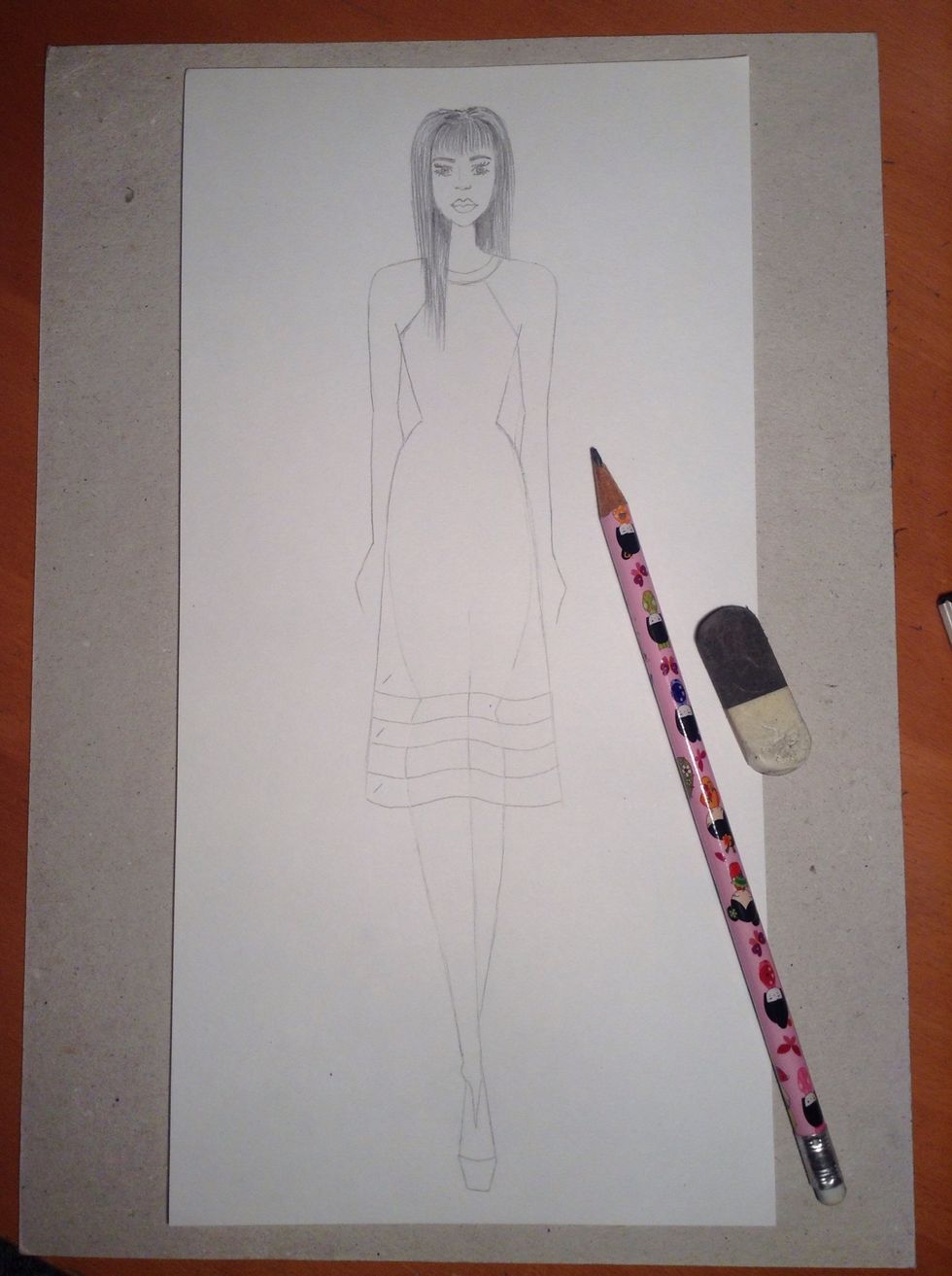 Draw your fashion illustration in pencil. You can go over this in pen and even add colour.