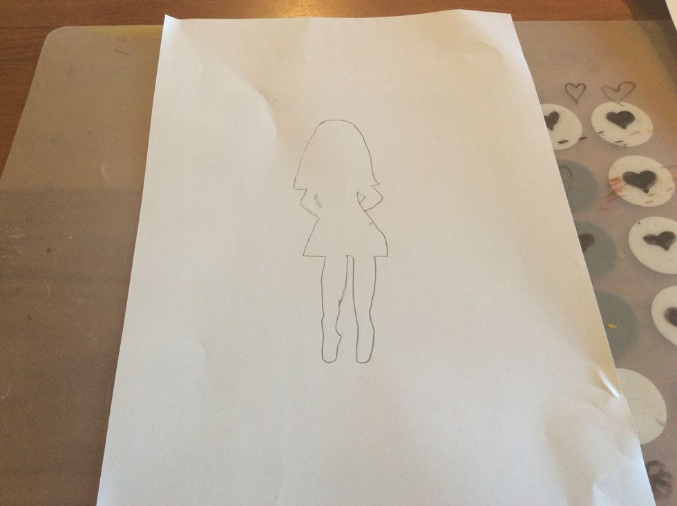 Draw your figure on the paper with a pencil ( pen or pastel).