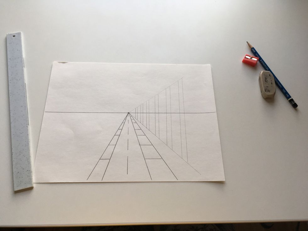 Draw your poles or tree trunks keeping your ruler perpendicular to your horizon line.