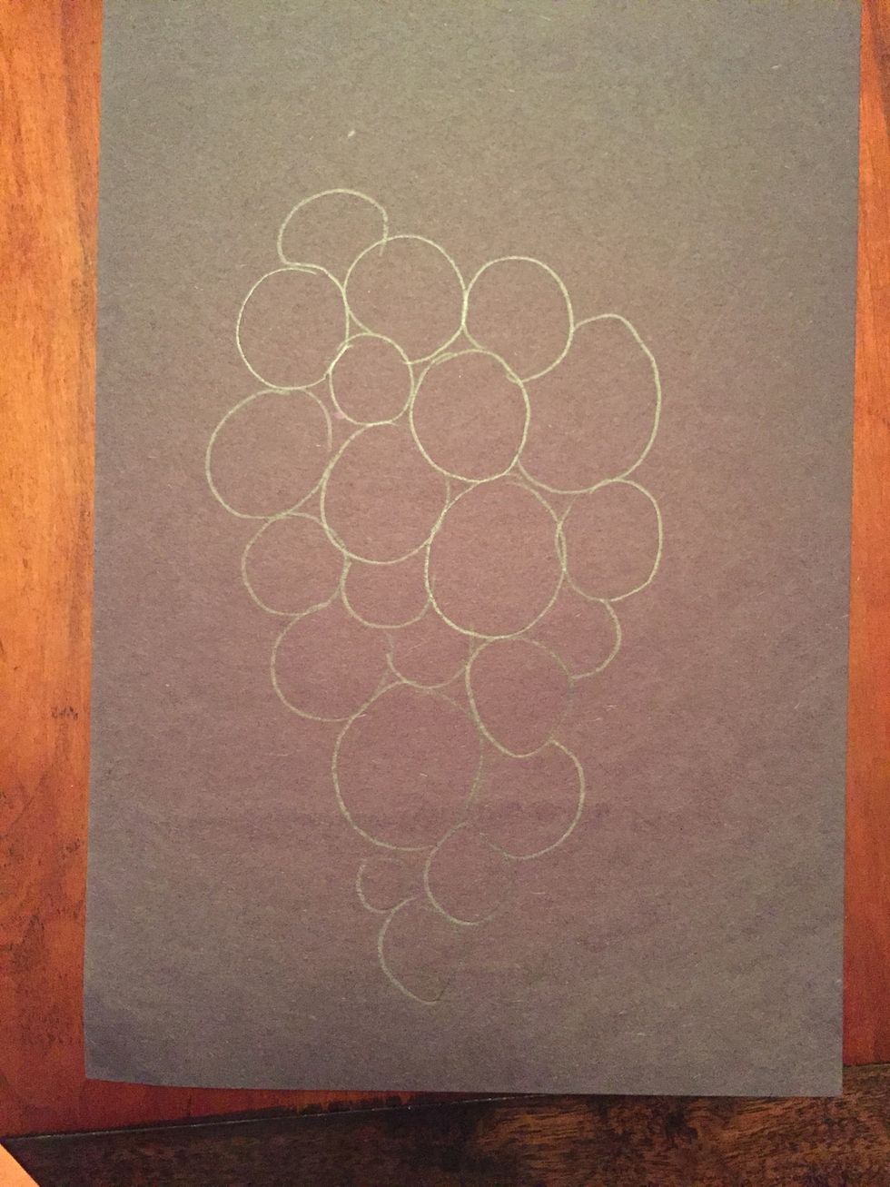 Draw your still life. You are drawing grapes. Draw them big enough to add value inside. Overlap them and vary the size ( some big some small).