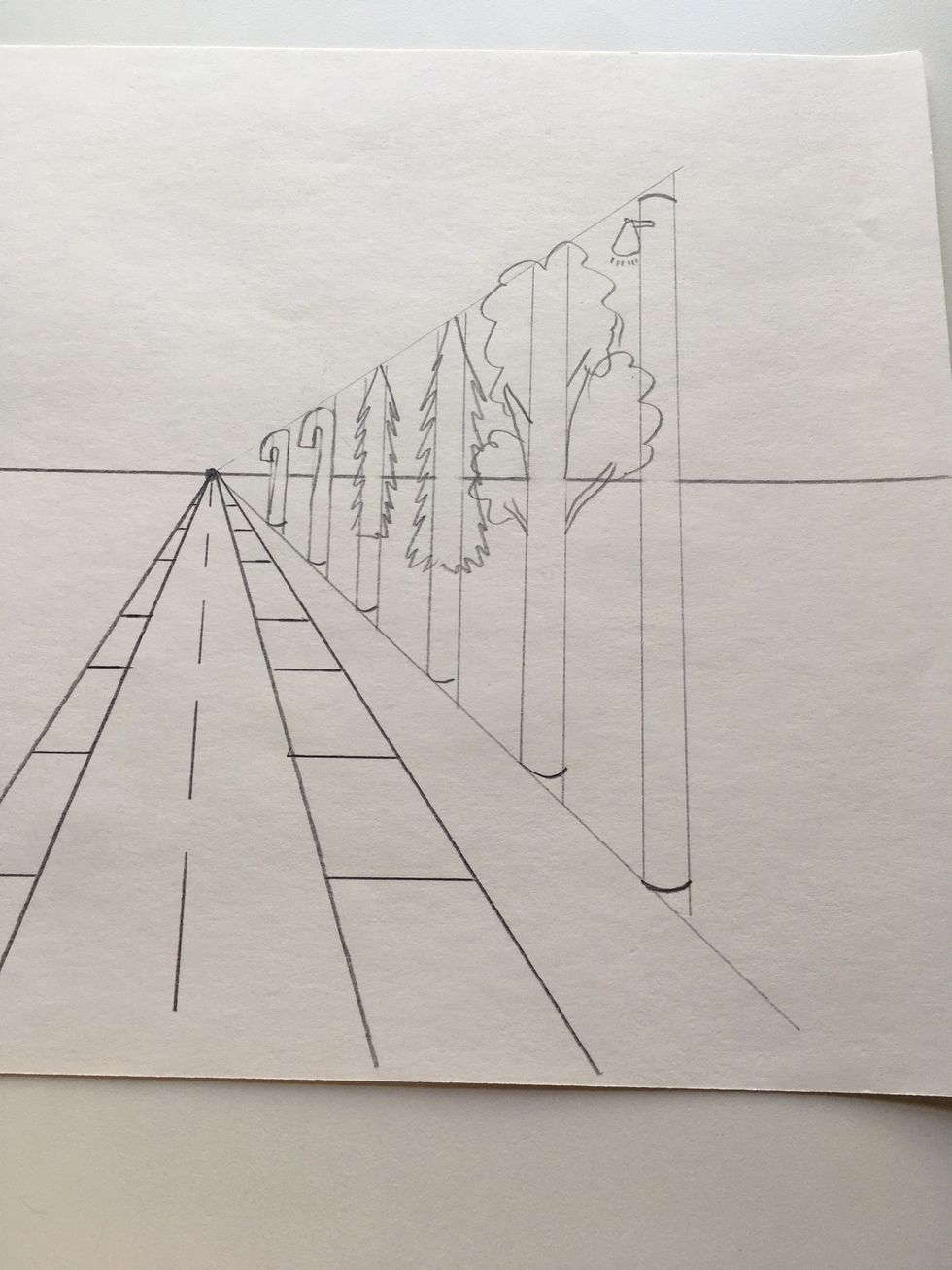 Draw your trees or candy land candy canes if you want.  They get smaller as they near the vanishing point.
