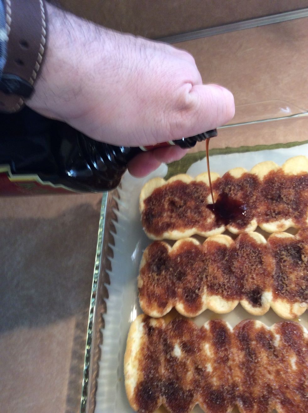 Drench the lady fingers with coffee liqueur.