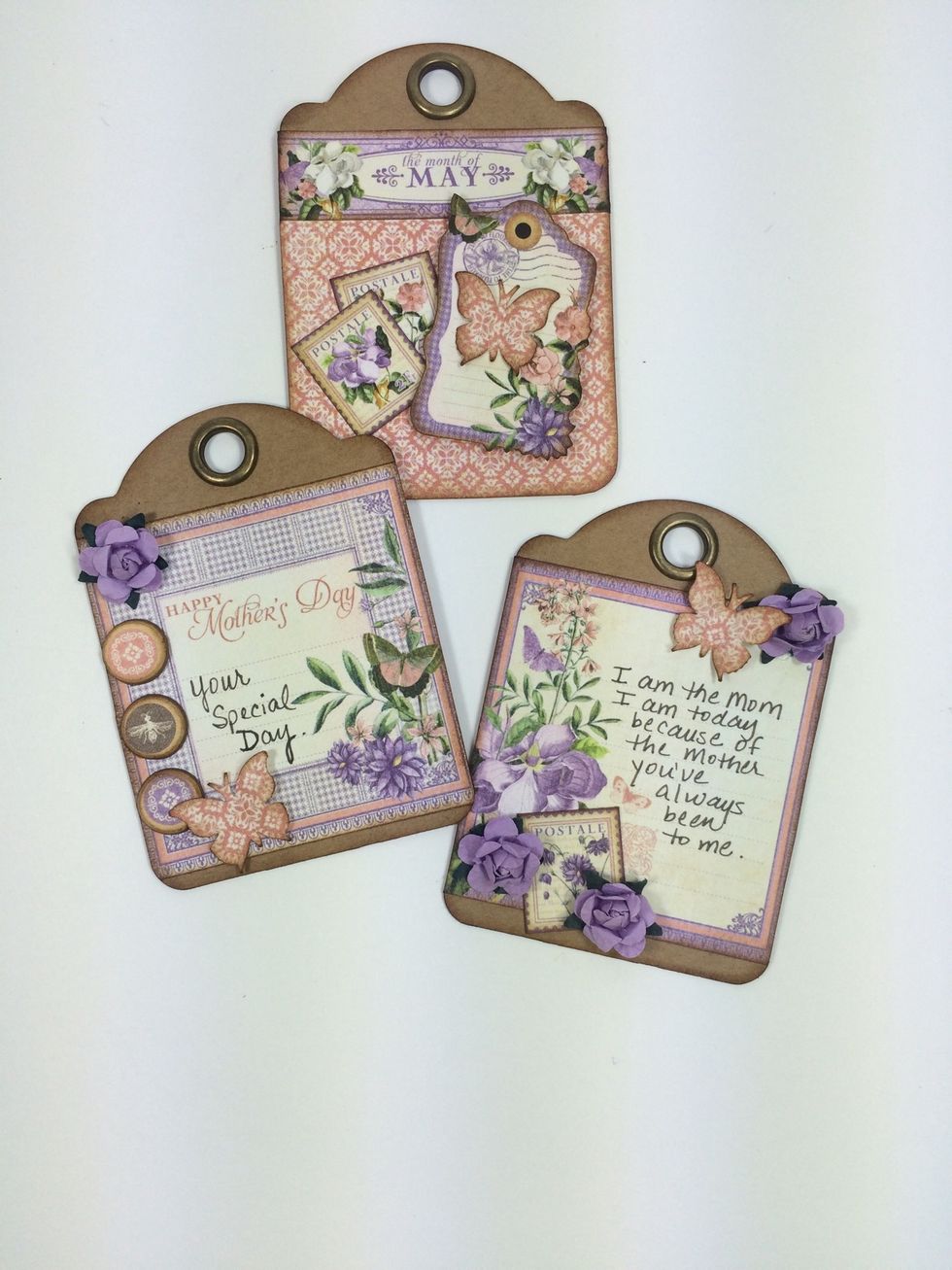 Dress up the three ATC tags with cut-aparts, flowers, and chipboard pieces as desired. I used a small butterfly punch too.