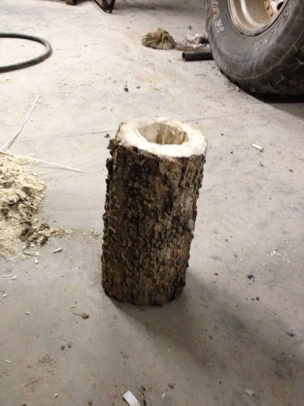 Drill a hole in the bottom piece big enough to fit the container you will use in it.