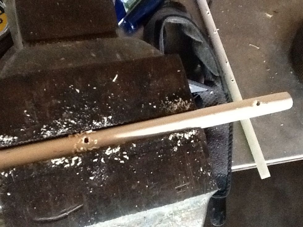 Drill holes the size of your small dowels (hangers) in 1 larger one (the post). I am using a vise to control my dowel while drilling because that takes 2 hands. Drill 2 holes, turn post 180.