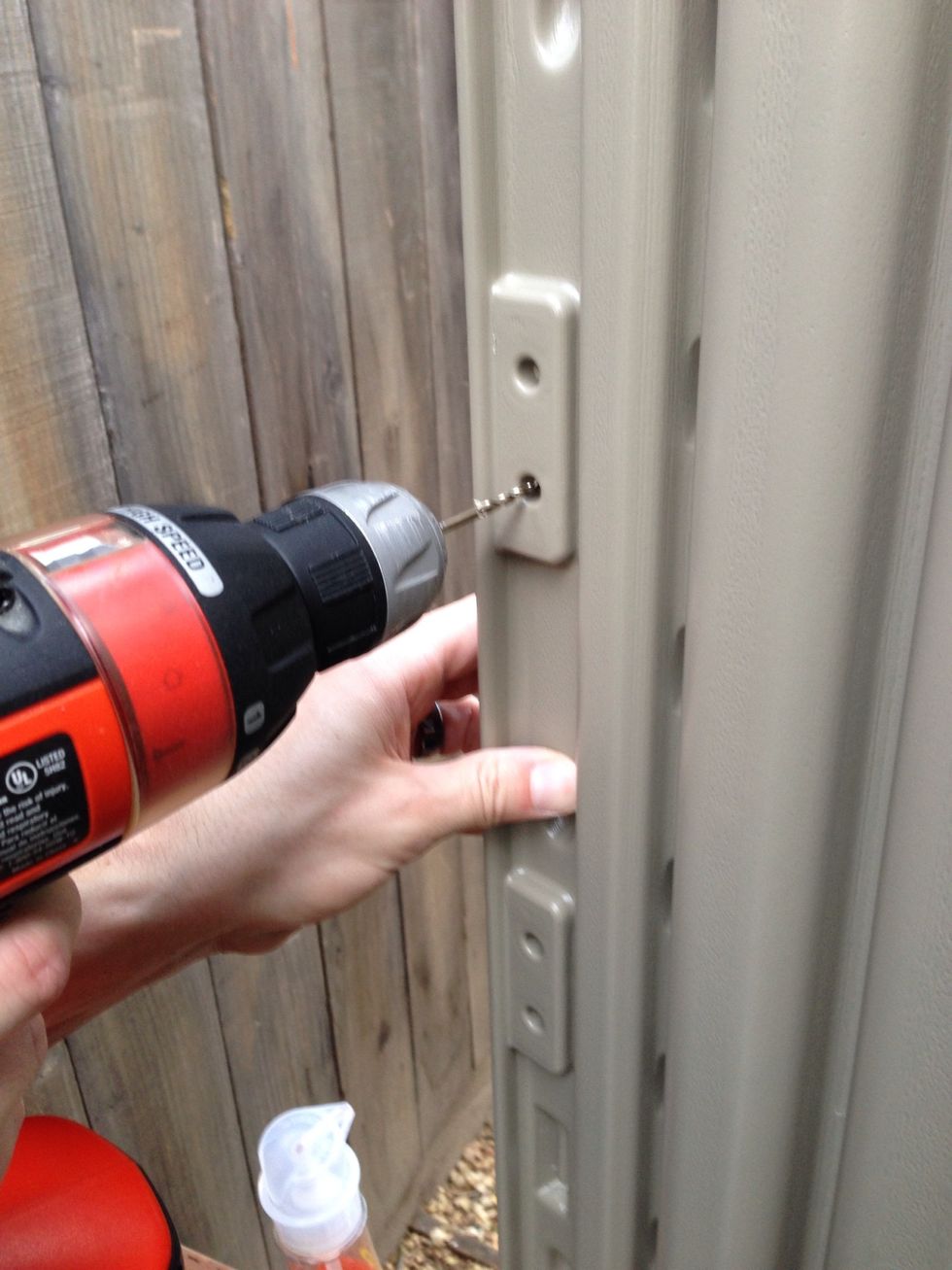 Drill pilot holes for the door knob.