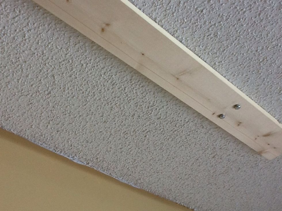 Drill pilot holes for the lag screws (I used 3 inch screws). Tighten them and repeat on the other end - distance recommended is 48 inches apart.