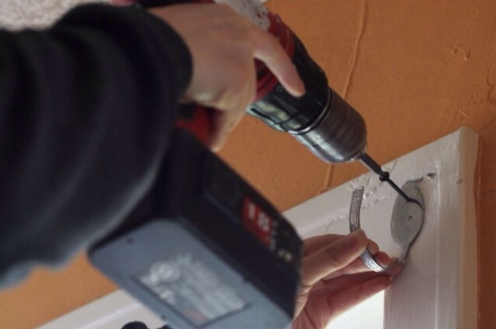 Drill the spoon hooks on to the wall or window frame. Depending on how big the window is you may need more than two hooks.