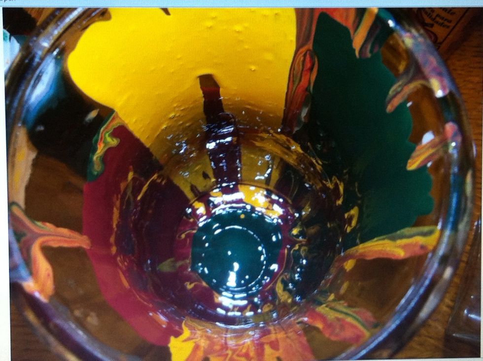 Drip or pour the paint color of your choice down the side of the vase. Let it pool at the bottom and then turn the vase on its side and let gravity pull the paint around the vase.