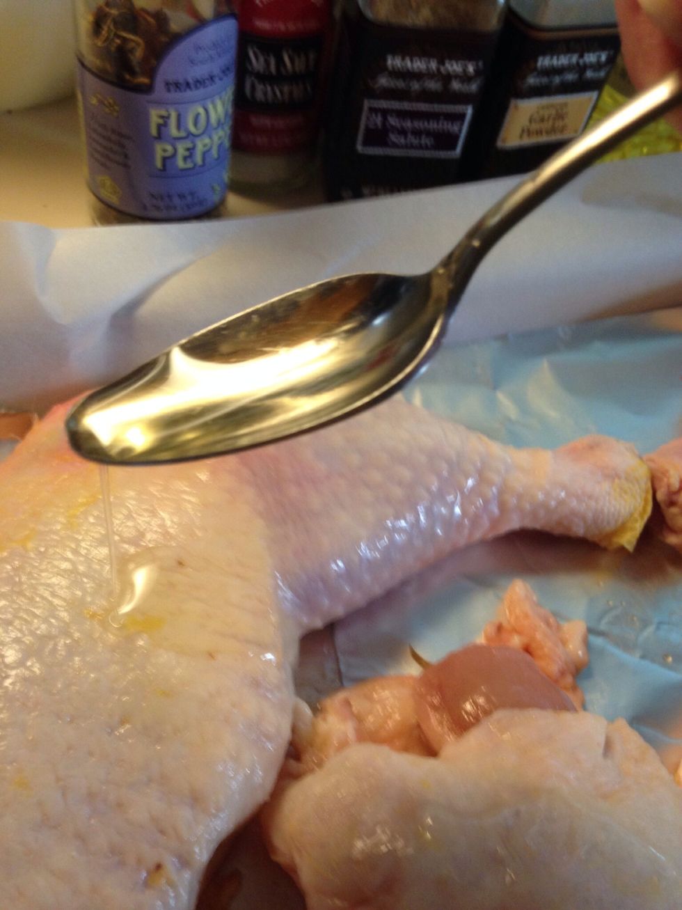 Drizzle a bit of oil over each piece of chicken, then squirt lemon juice over that.