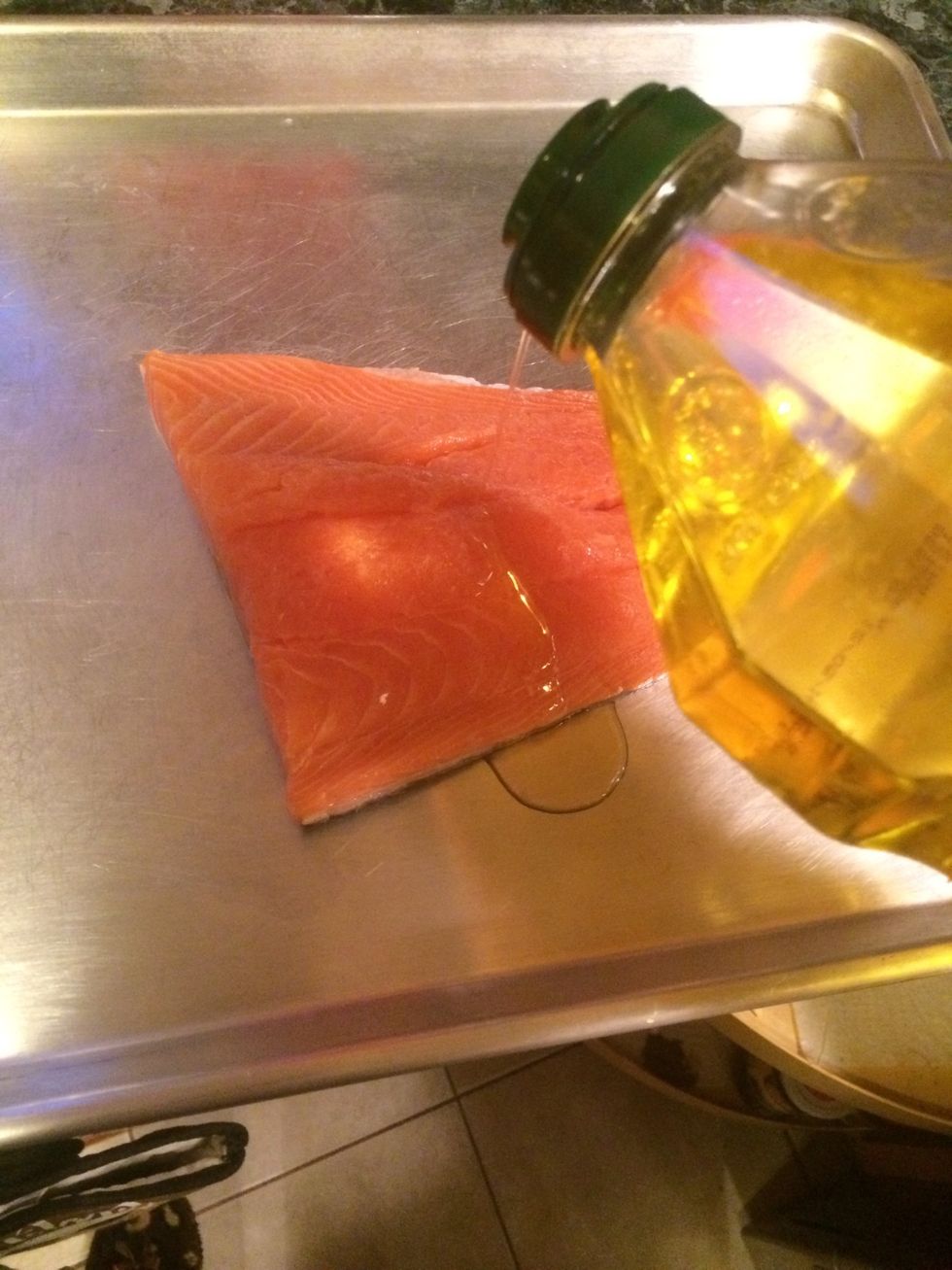 Drizzle about a tbs of olive oil over the surface of the salmon.