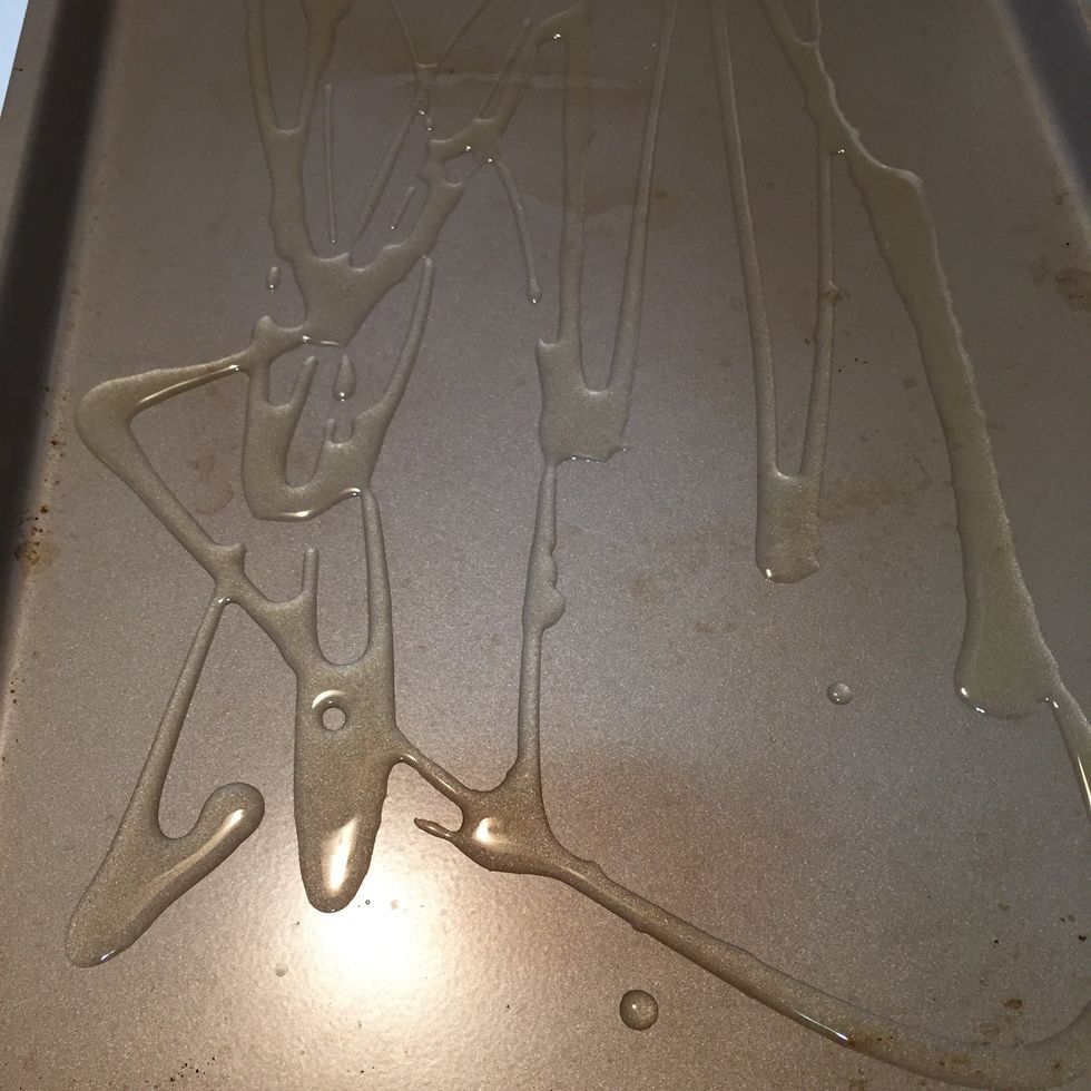 Drizzle and brush olive oil in a pan.