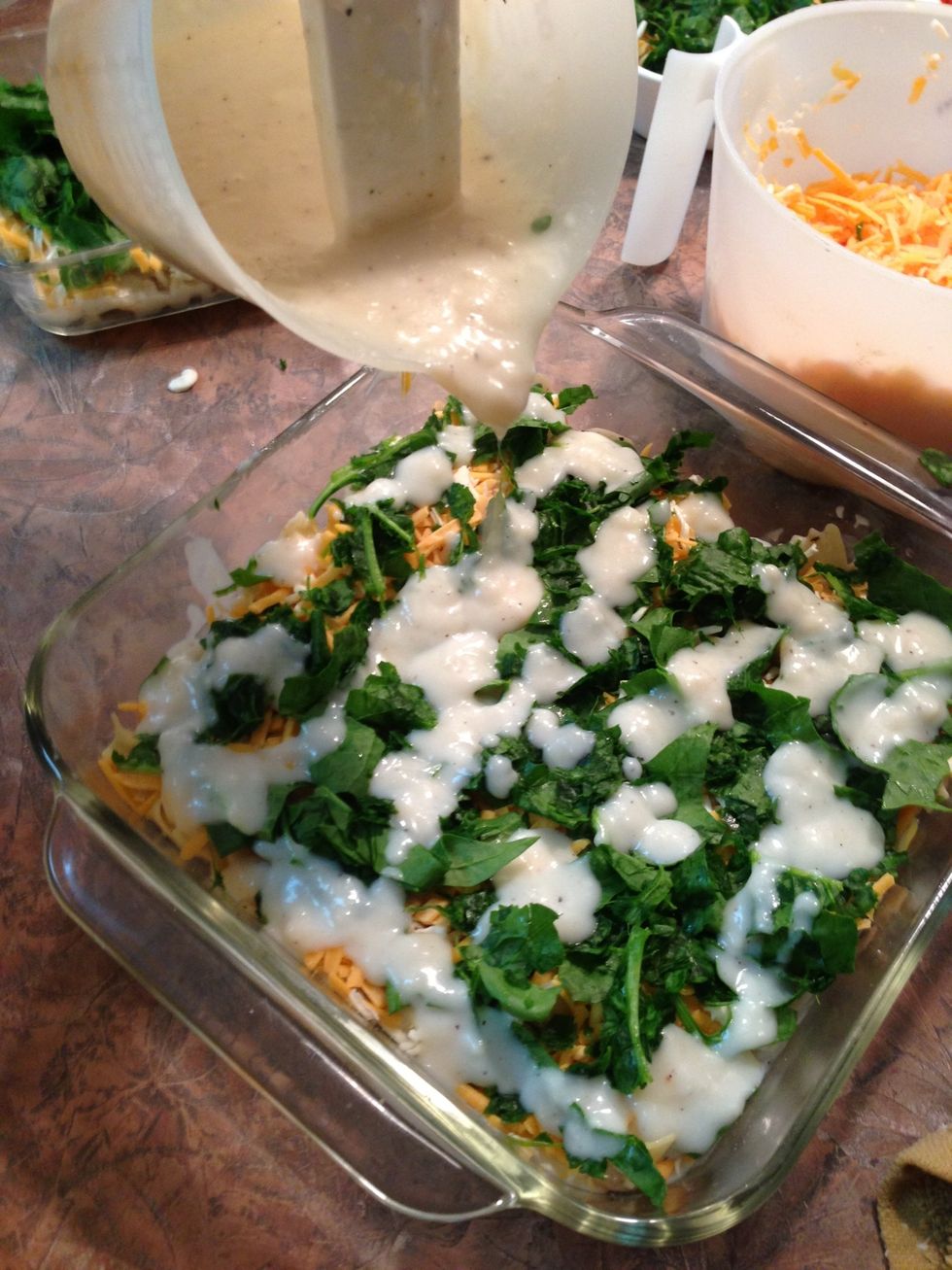 Drizzle half of white sauce evenly over spinach layer.