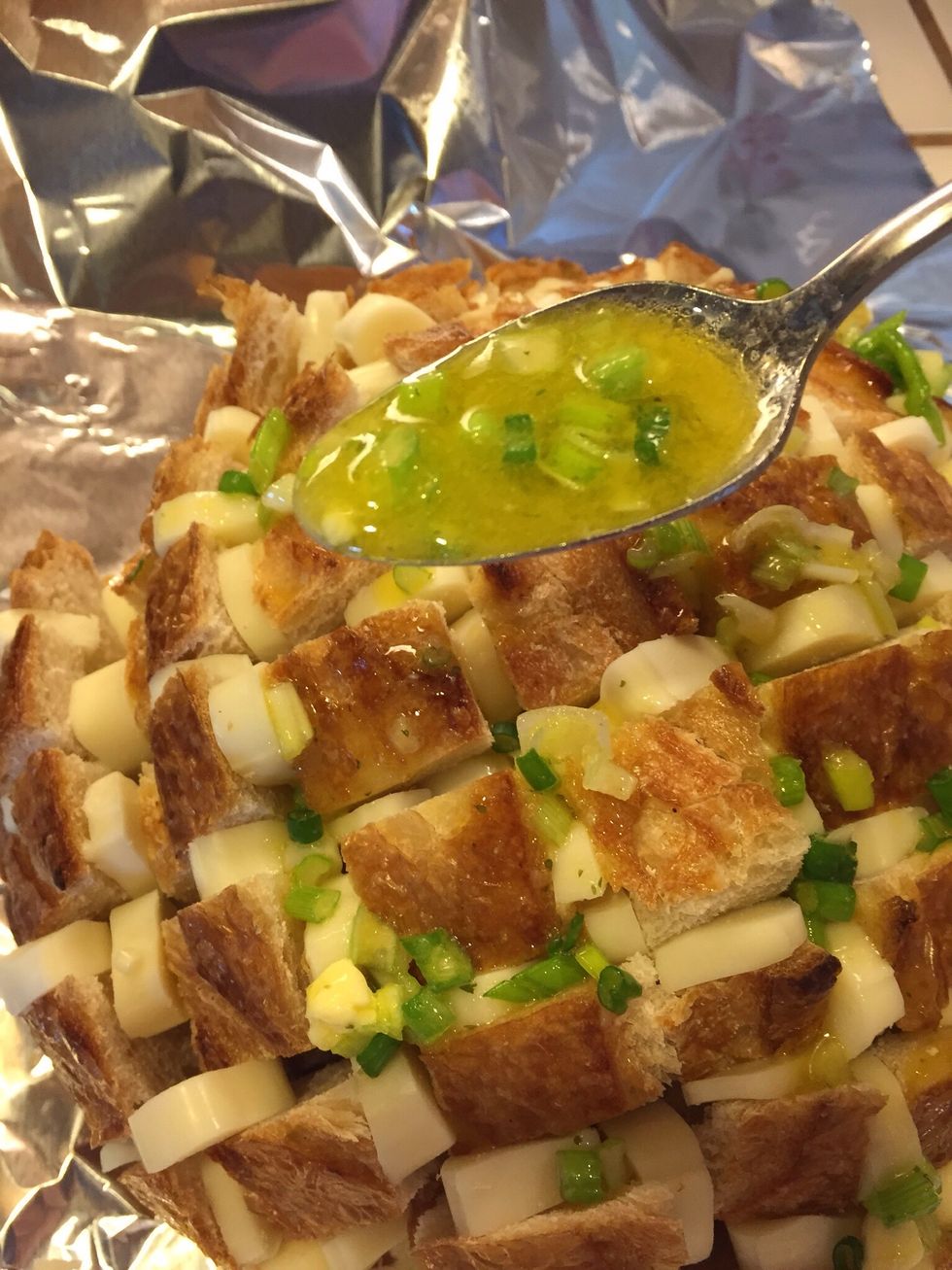 Drizzle melted butter mix over the bread.