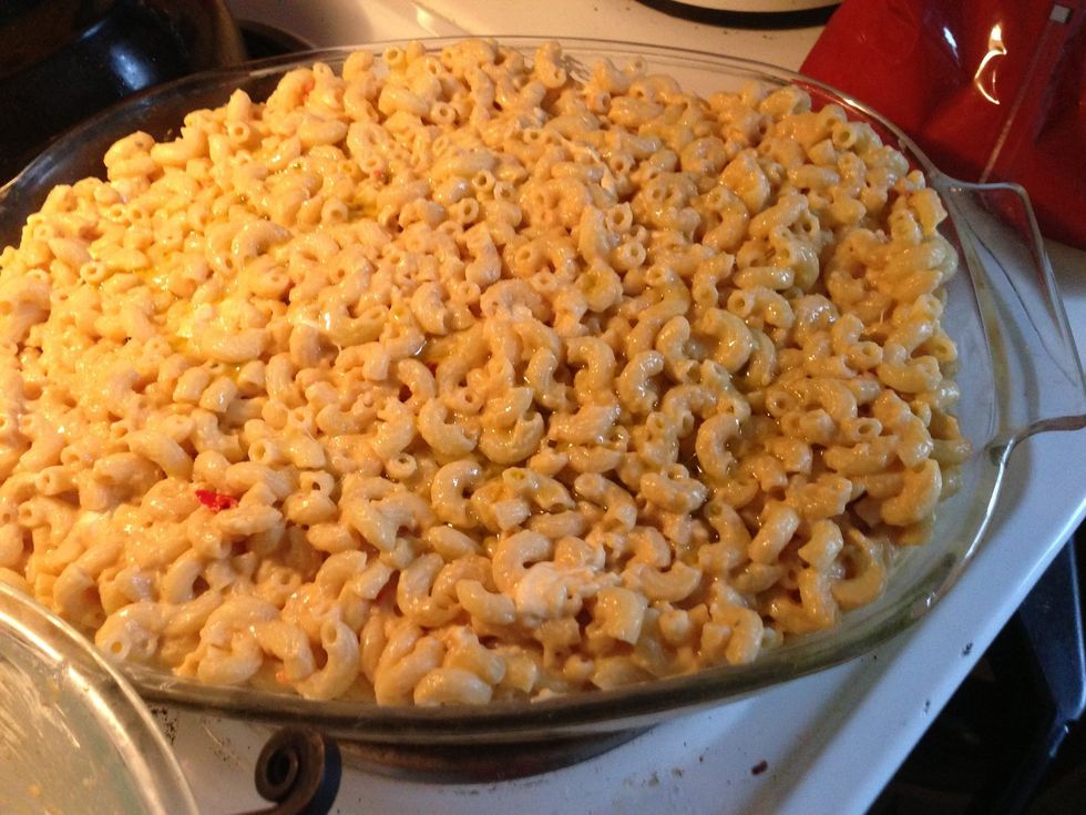 Drizzle olive oil in bottom of a large baking dish. Pour in the pasta mix. Drizzle more olive oil on top.