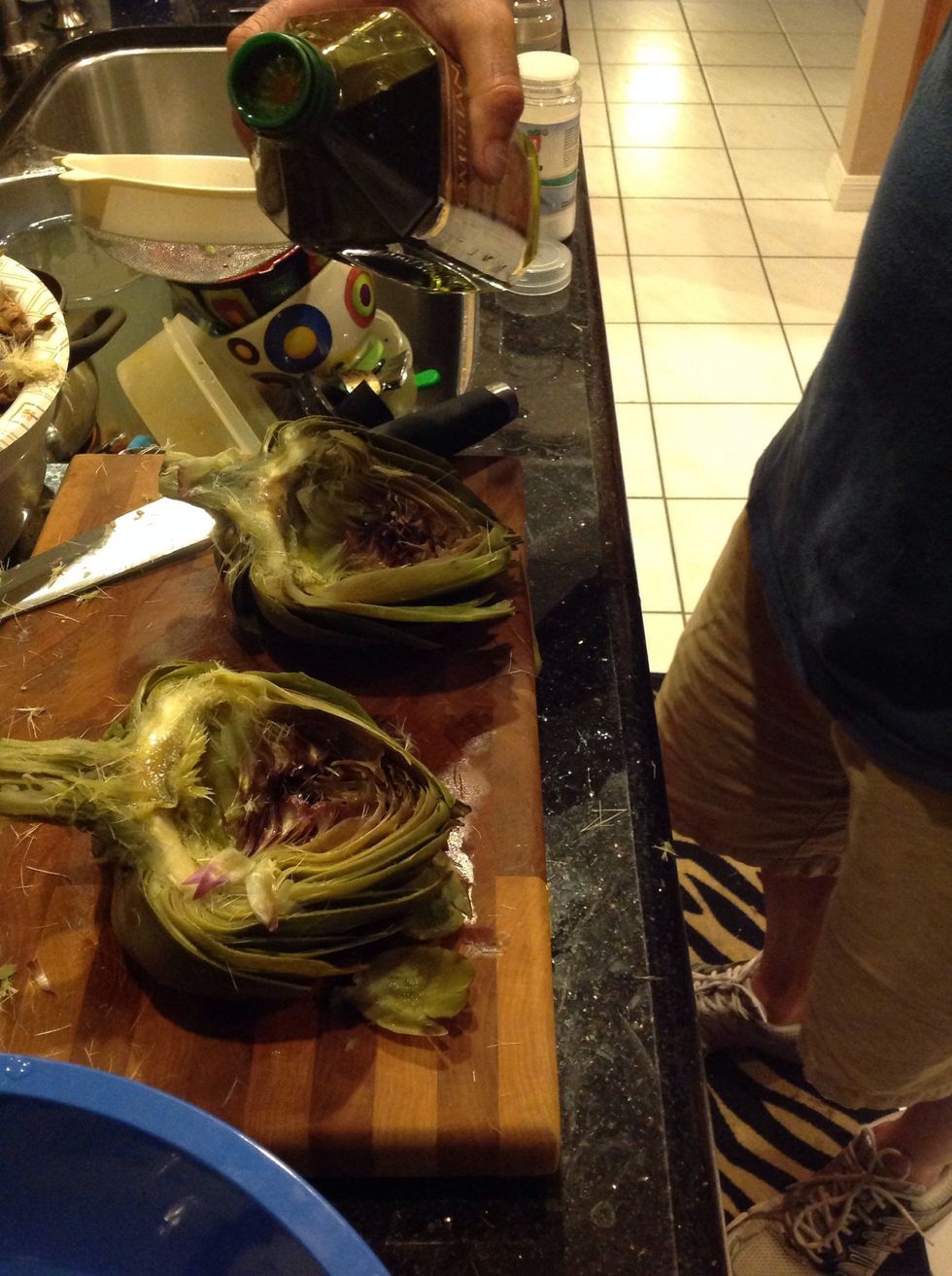 Drizzle olive oil on artichokes liberally, but do not drench.