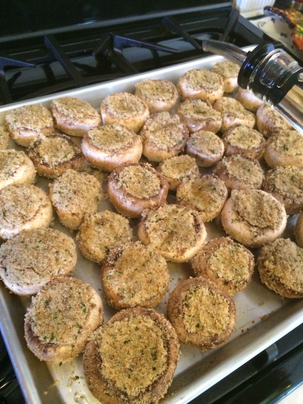 Drizzle some olive oil over each shroom and place the cookie sheet in a preheated 400 degree oven for 25-30 or until the tops are brown and they have shrunken a bit.