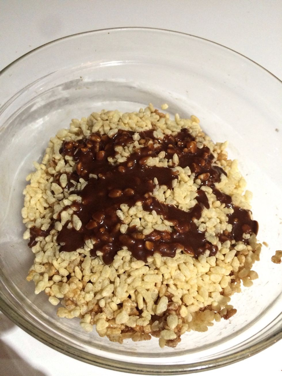 Drizzle the 3/4 of the gooey chocolate lava onto the rice bubbles and combine so every grain is coated.
