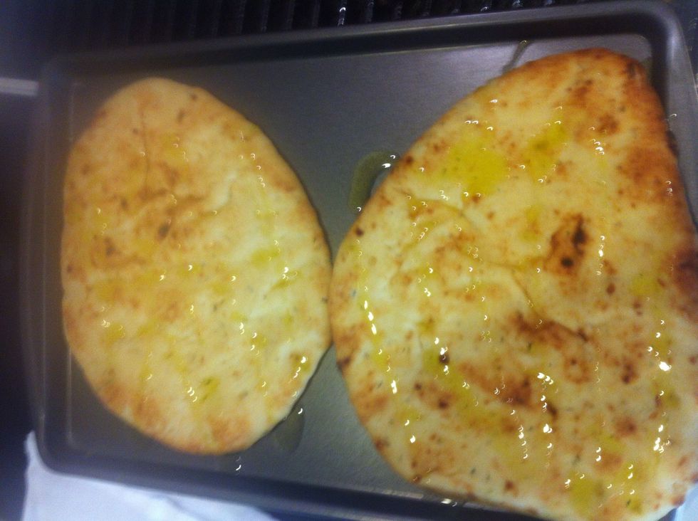 Drizzle the naan with a good olive oil.