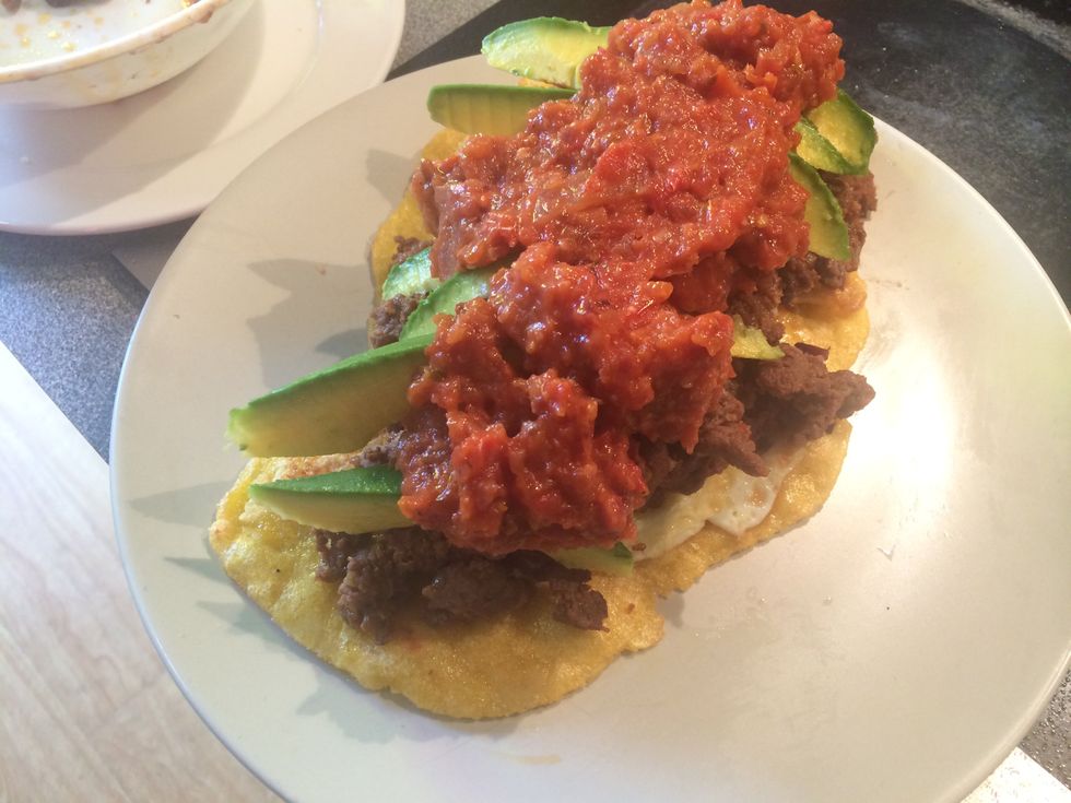 Drizzle the salsa on to the avocados.