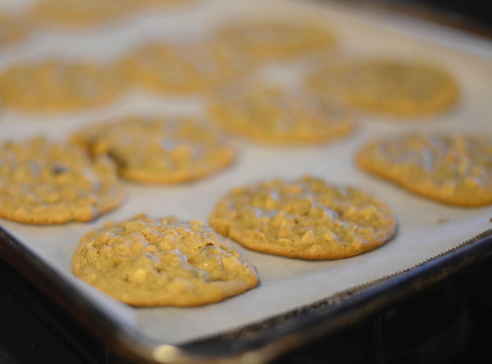 Drop 20 portions of dough into a parchment lined cookie sheet, and bake for 8 minutes in an oven preheated to 350 degrees Fahrenheit.