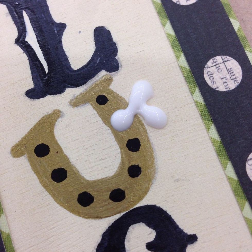 Drop 3 small spots of Tacky Glue near the top, outside edge of the horse shoe U.