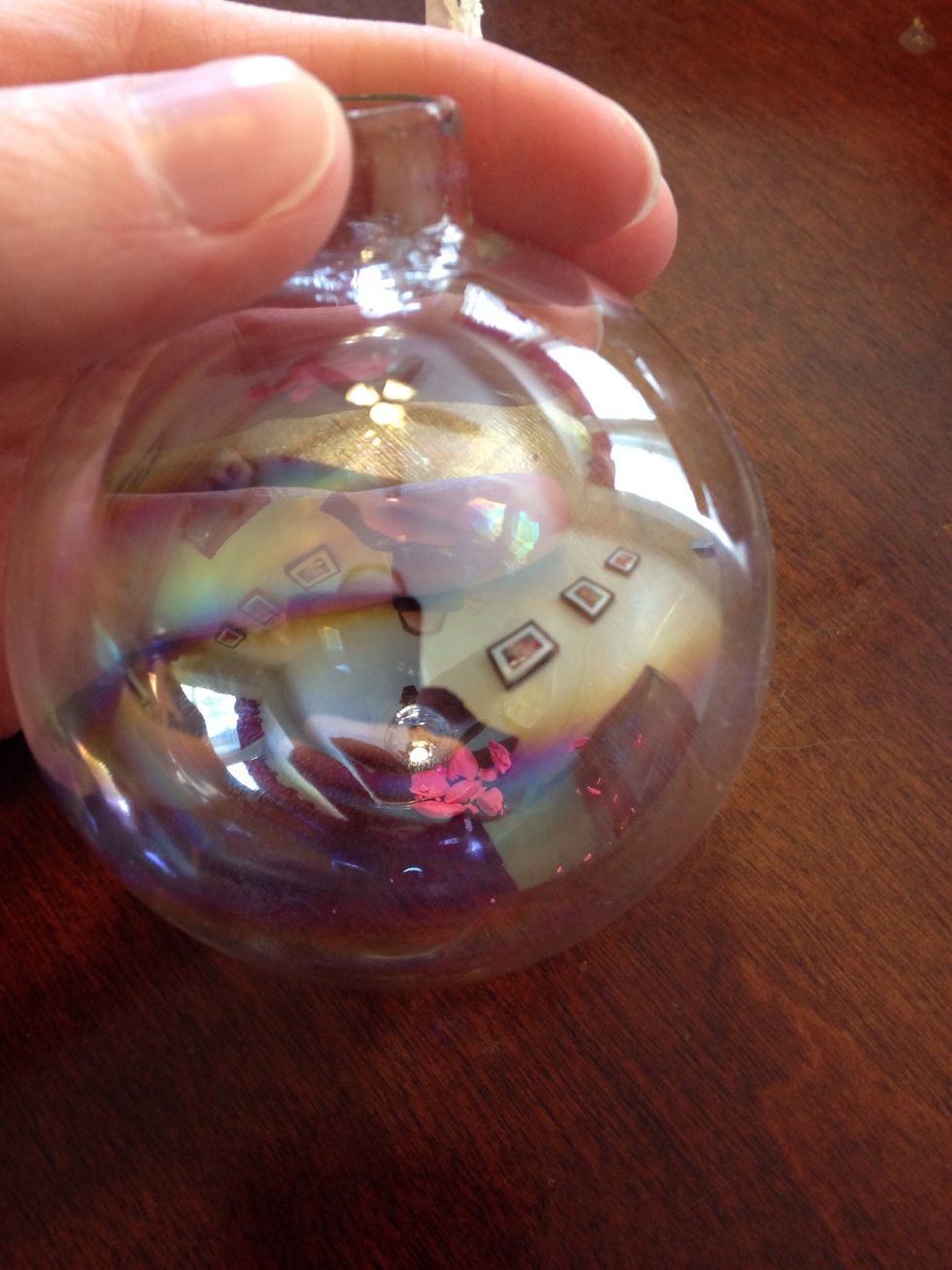 Drop a few crayon shards in the ornament and put the top back on.