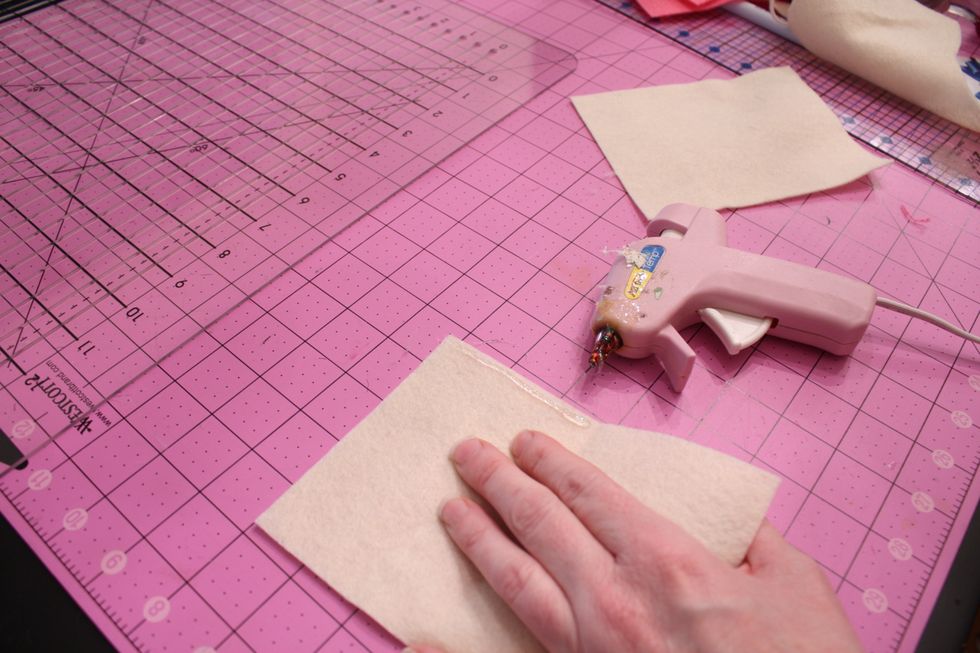 Drop a line of hot glue down to the fold mark and press closed