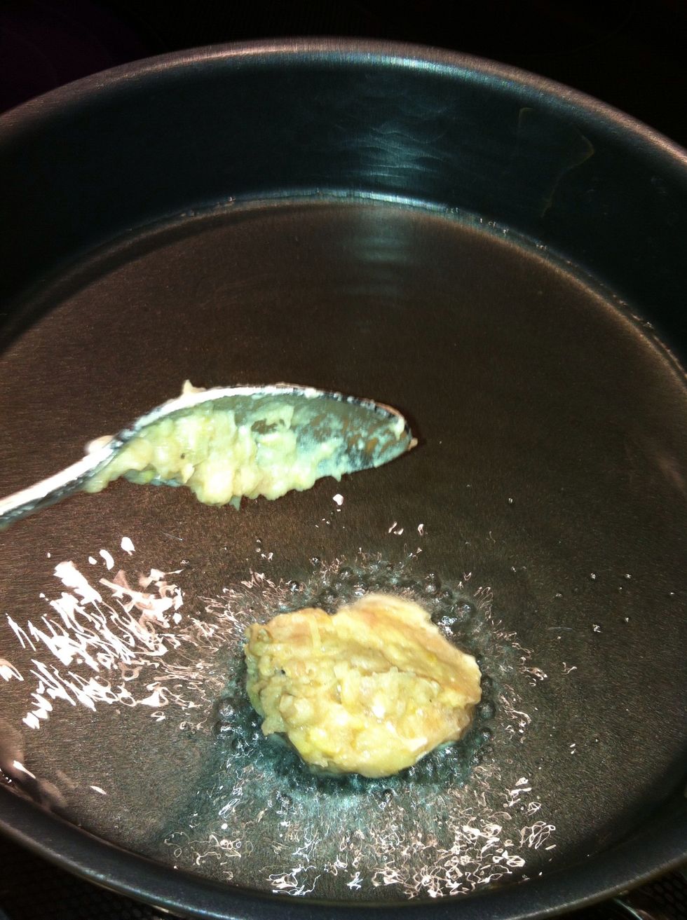 Drop a spoonful of the meat mixture into the hot oil.