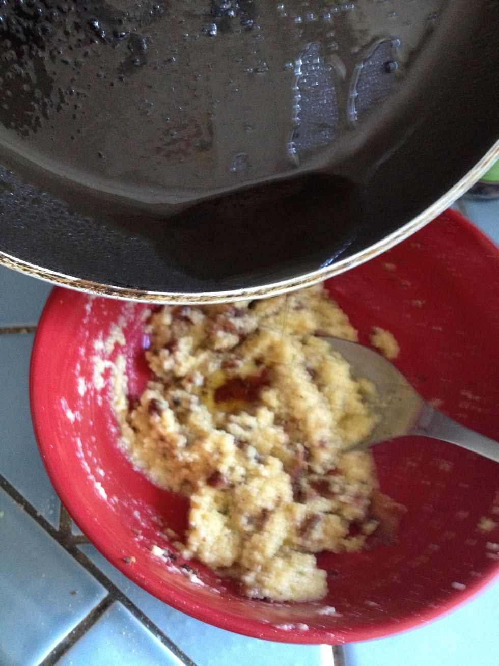 Drop a tiny bit of the cooled bacon drippings to the cheese-egg mixture. Make sure the bacon grease has cooled down so you don't end up with scrambled eggs.
