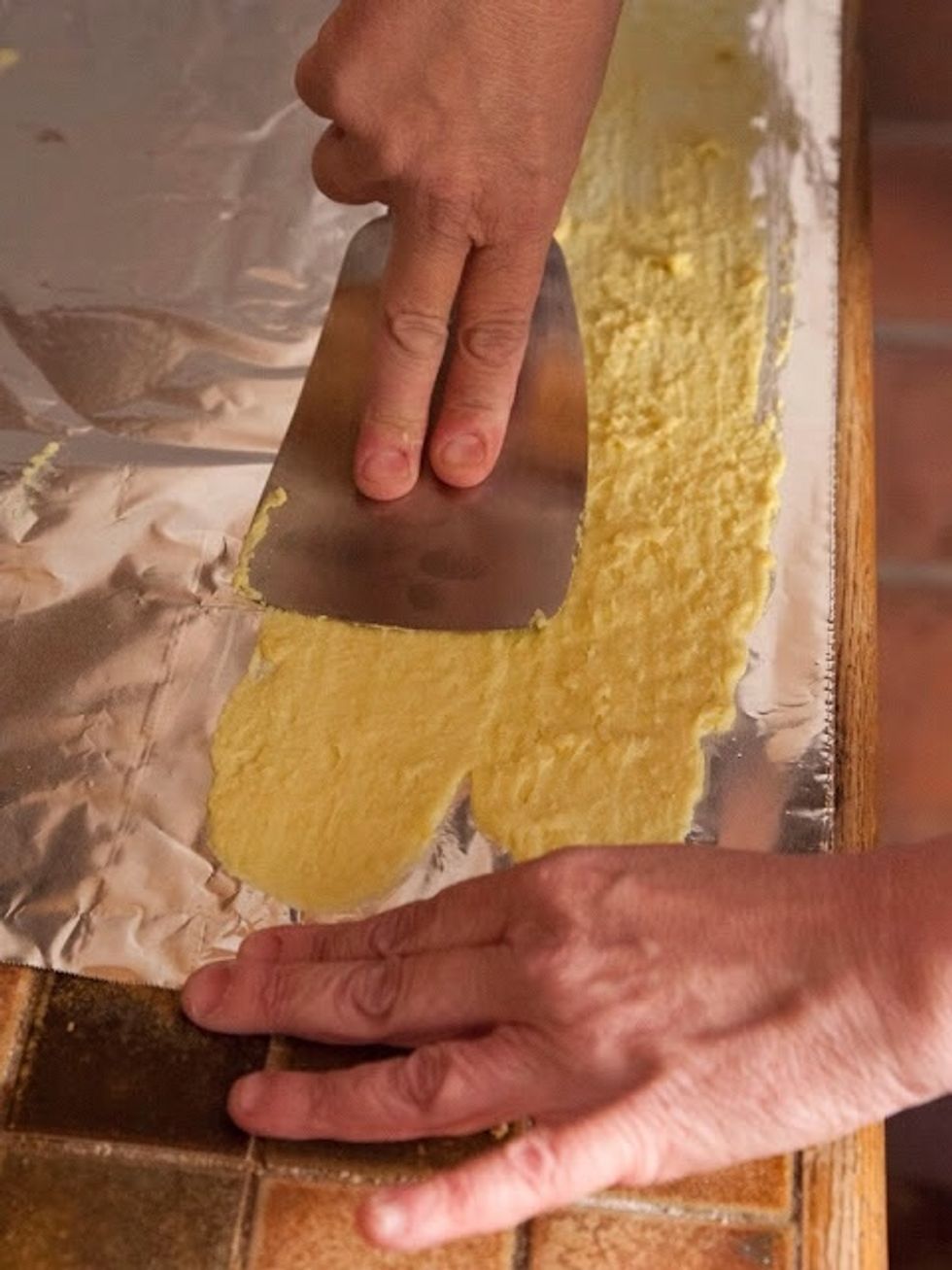 Drop another strip next to the one you just spread, and then spread that one too. Keep doing this until the foil is covered with a thin smear of the batter. Let the batter set for 5 minutes.