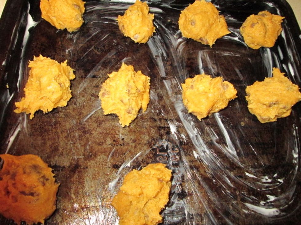 Drop by tablespoons on a greased baking sheet. Bake at 350 Fahrenheit for 12 minutes.