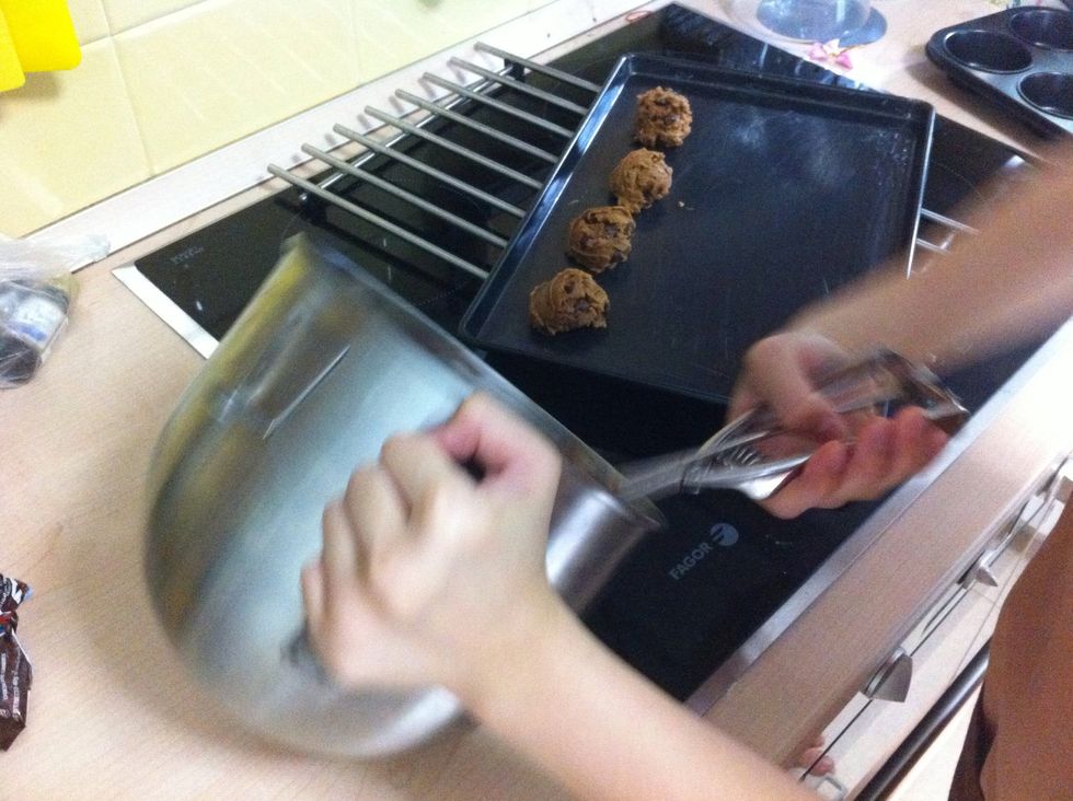 Drop cookies dough onto a greased cookie sheet about 3inches apart.Gently press down the dough with back of a spoon to spread out in to 2inch circle