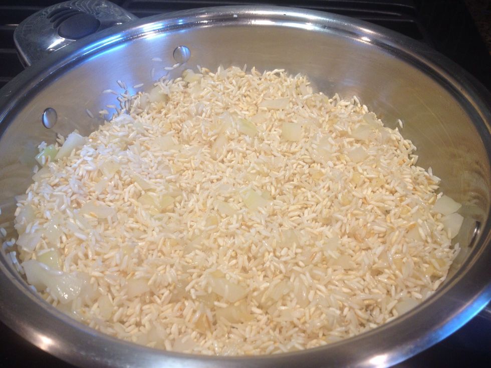 Drop down to low. Add onions and garlic. Brown for a couple of more minutes but pay attention. If it looks like the onions or garlic are starting to burn just move on to the next step.