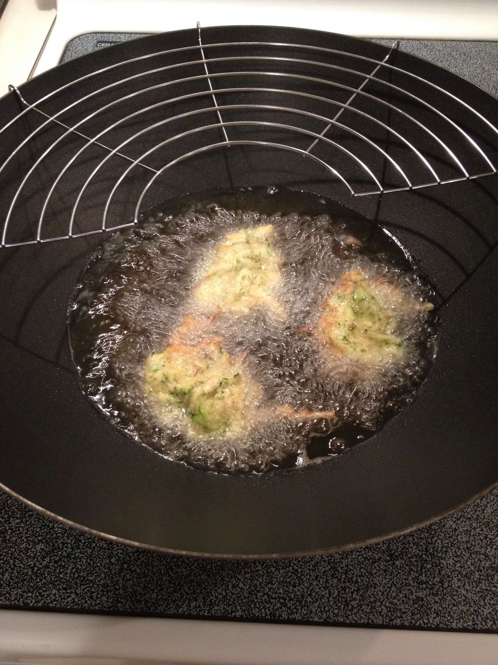 Drop heaping spoonfuls of zucchini mixture into hot oil. If using an oil strainer, add it to pan now.