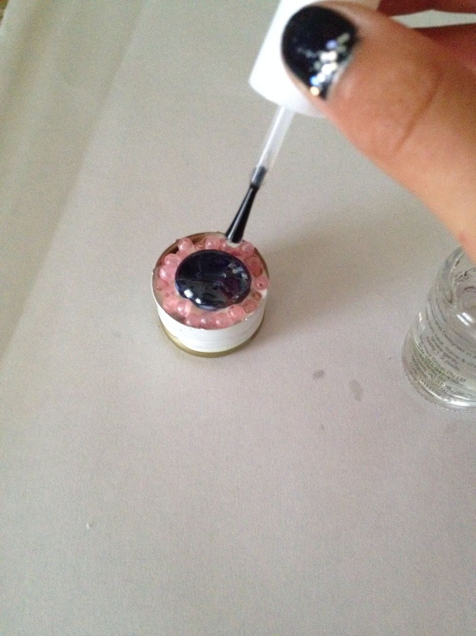 Drop it over the beads to set them in place better - it covers all of the beads but doesn't look like glue. I recommend you DEFINITELY do this step.