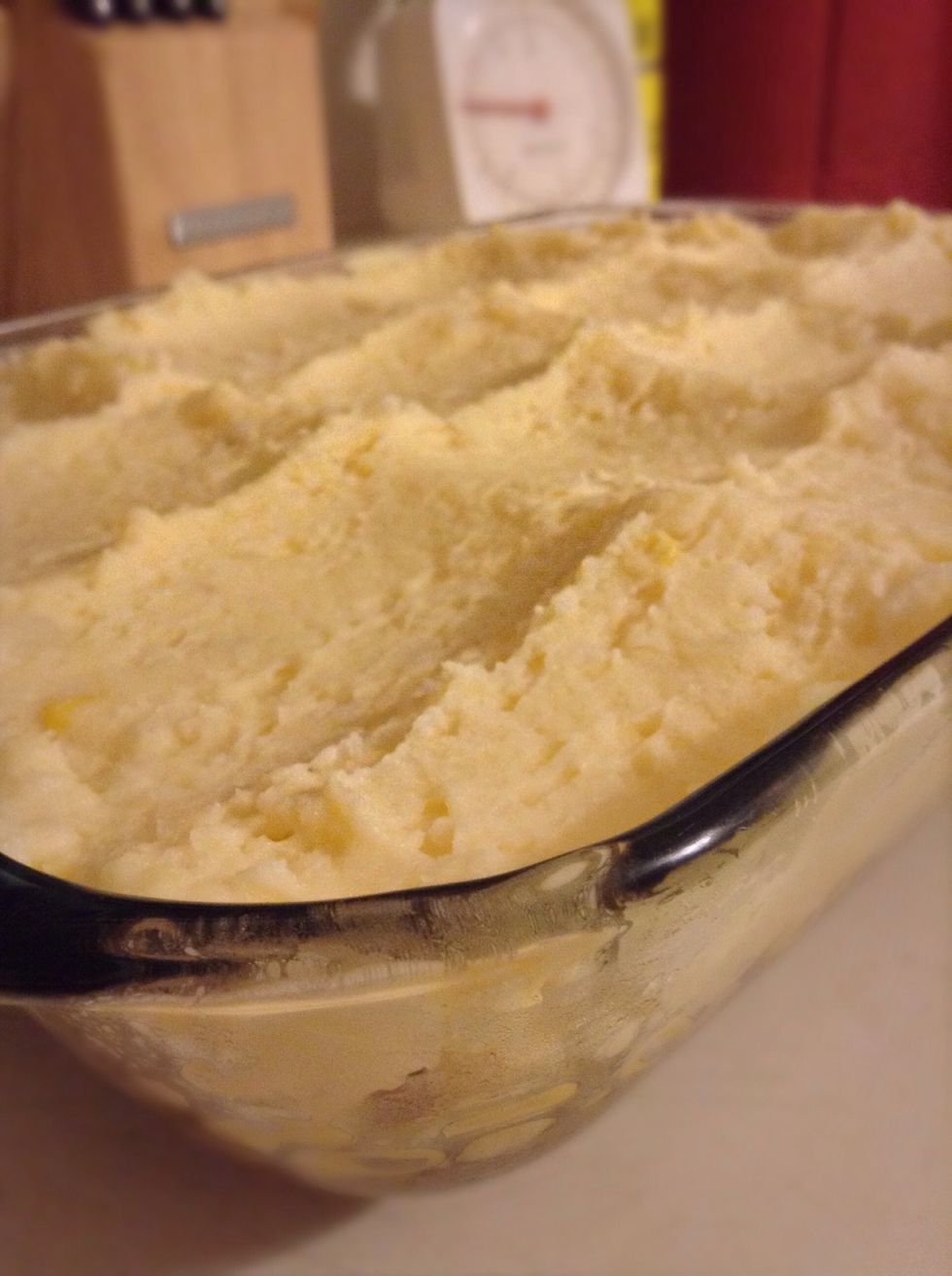 Drop spoonfuls of mashed potatoes evenly over the surface, and then use a spatula to smooth the potatoes into an even layer. Create little peaks with the tip of the spatula.