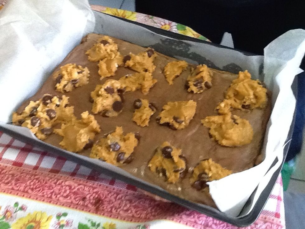 Drop spoonfuls of the peanut butter mixture on top of the partially cooked brownies. Put the tray back into the oven for 25 to 30 minutes, or until the top is light brown.