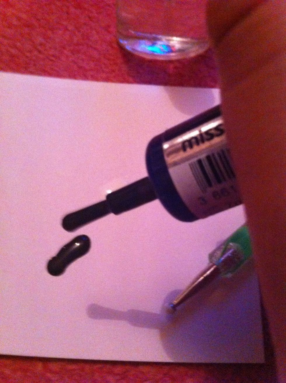 Drop the black polish onto the paper.