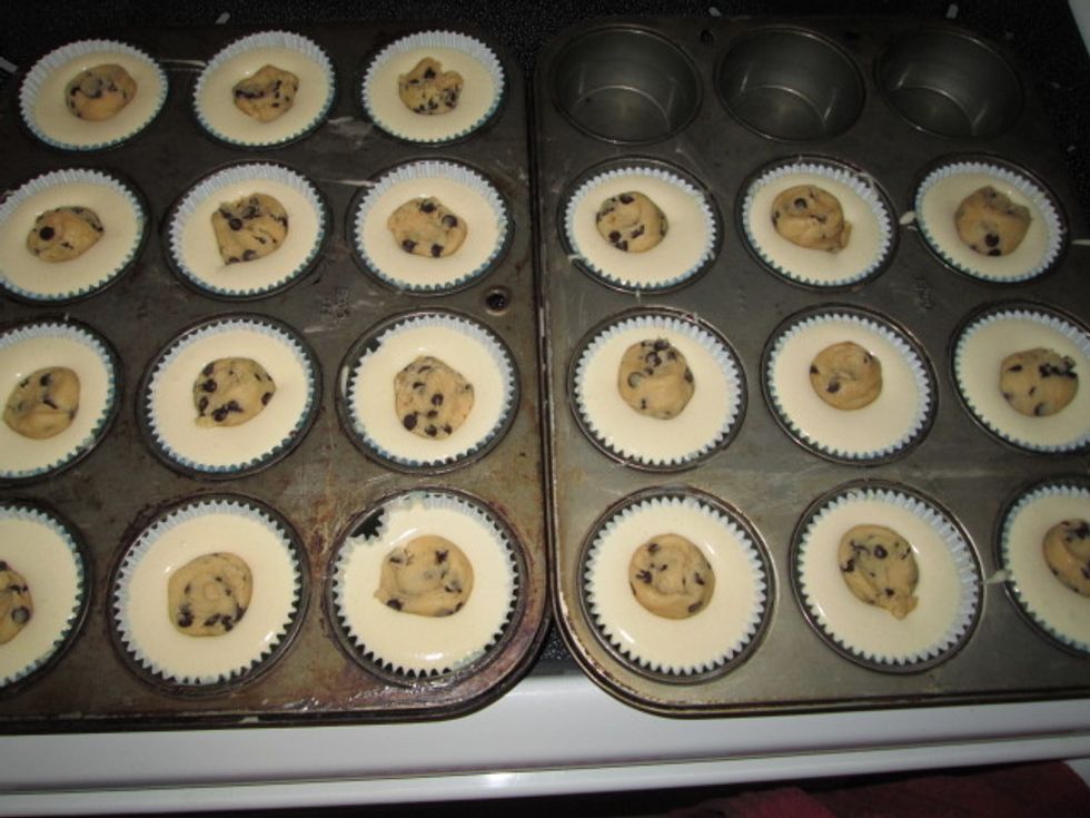 Drop the cookie dough in the middle of each cupcake.Bake at 350 Fahrenheit until a toothpick inserted into the cake portion (not the cookie dough ball) comes clean. About 20 minutes.