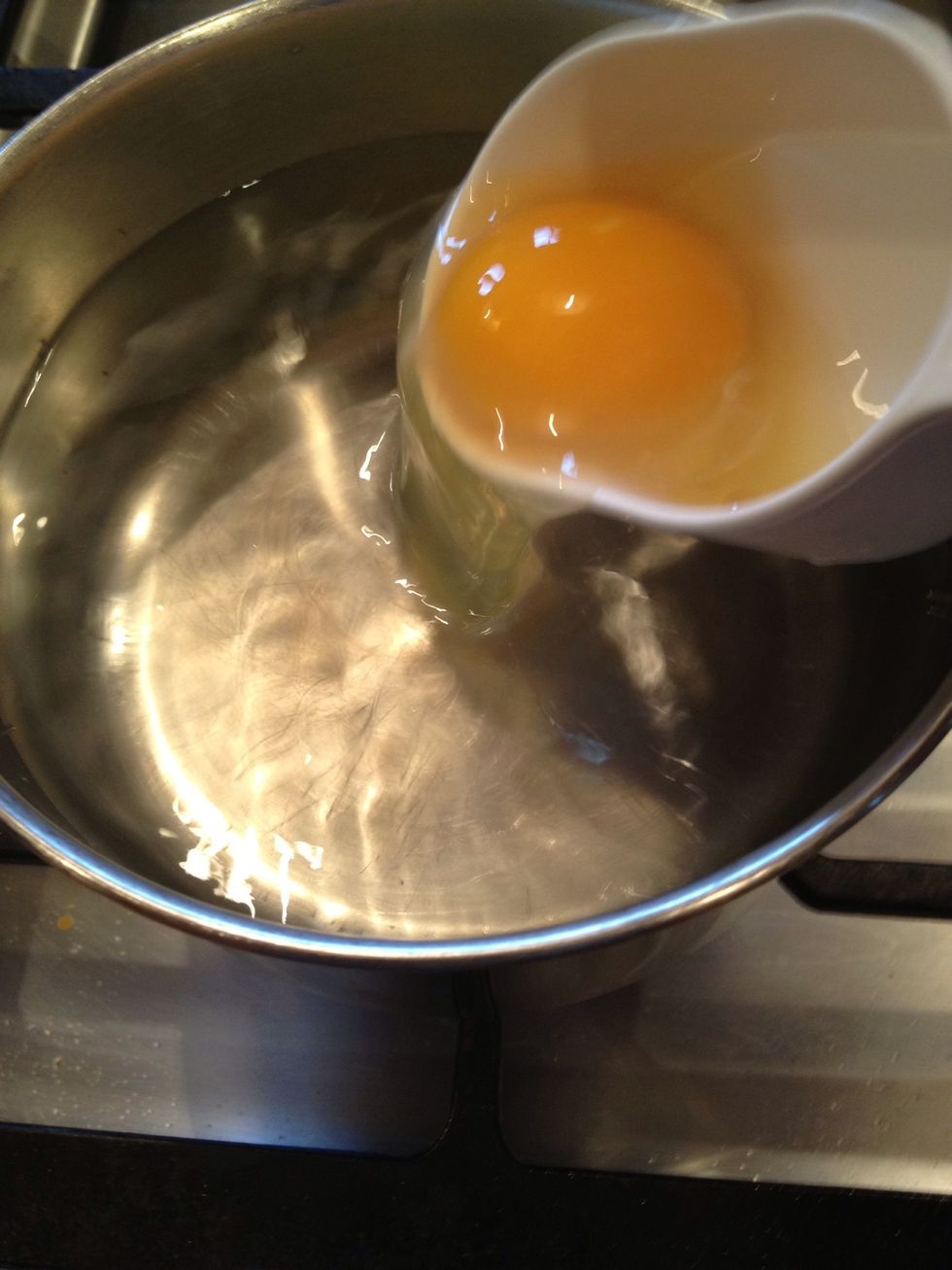 Drop the egg gently into the swirling water, right at the surface, so it slides in gently.