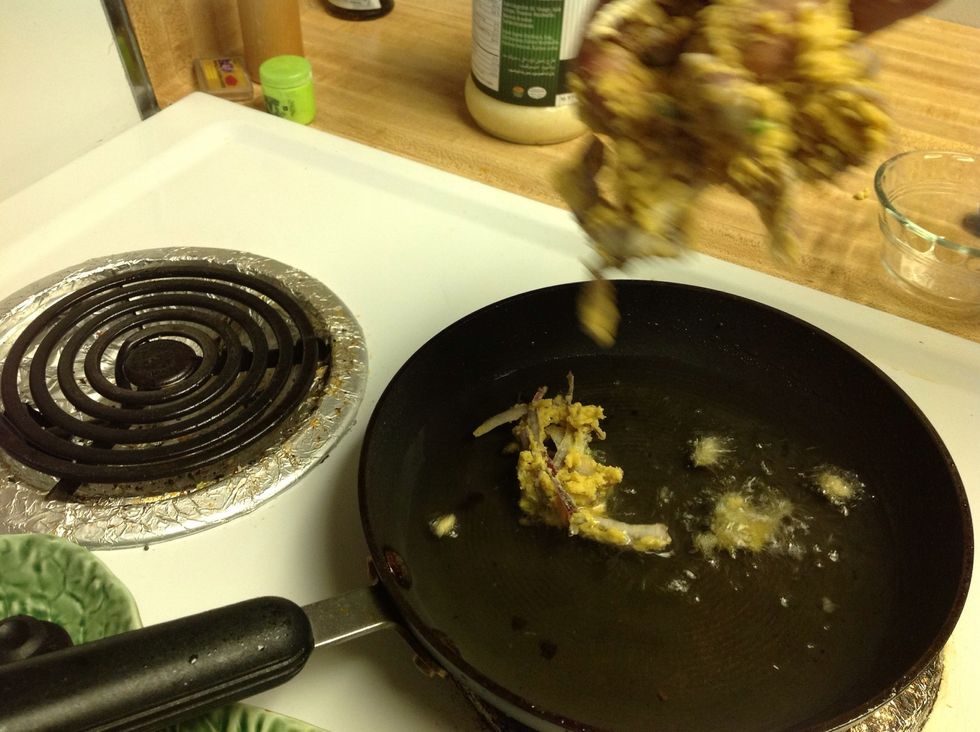 Drop the mixture into the oil. Drop with a fork or use hand.