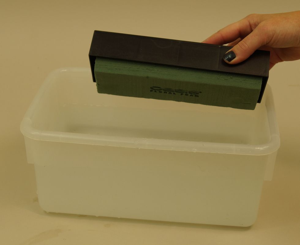 Drop the table deco in a bucket of water. It will float, and as it absorbs the water, it will sink. Do not forcibly submerge under the water. Allow it to saturate on its own.